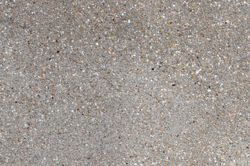 Rough texture of gray-brown wall. Wall from concrete with pebbles and cracks. Texture background for design
