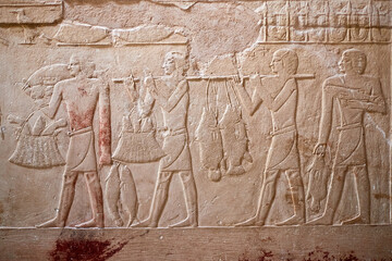 Mural from the tomb of the vizier Kagemni showing four men carying various fish they had caught - Kagemni mastaba, Saqqara