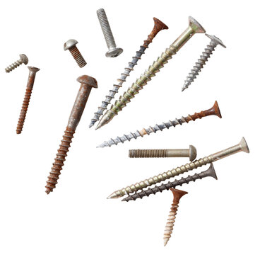 A bunch of different sized screws and nails are scattered on a white background