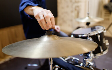 Fototapeta premium A person is playing a drum with a cymbal on top
