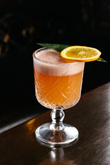 orange punch in a glass on the table