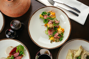 warm salad with beef and vegetables in a restaurant