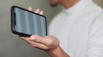 blank screen cellphone photo in hand