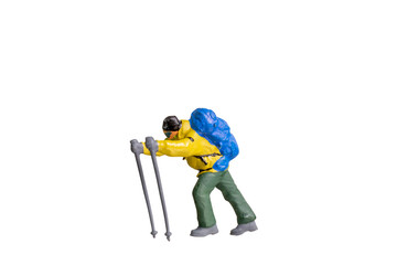 Miniature Figurine of a Trekker with Hiking Poles isolated on white background with clipping path