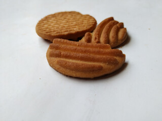 Round Whole Brown Color Biscuit and Cut Cookie isolated on white Background. Curve Shape pattern above the biscuit.