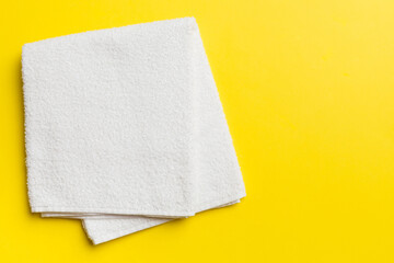Top view of white towels with copy space on colored background