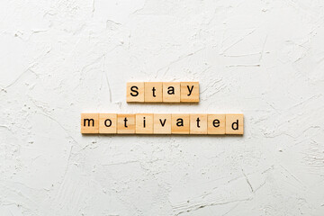 Stay motivated word written on wood block. Stay motivated text on cement table for your desing,...
