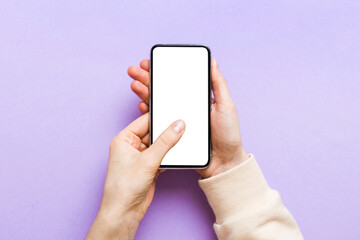 Top view of woman hands holding smart phone with blank copy space screen for your text message or information content. woman hand using phone white screen on top view