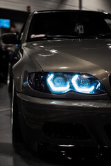 Headight of a grey car. Blue headlight.
