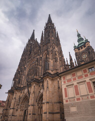 St. Vitus Cathedral at Prague Castle with dramatic gothic spires and detailed rose window under a...