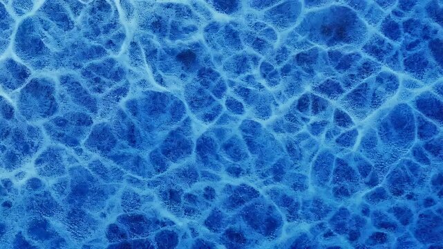 Textured icy blue background featuring a frosty appearance and intricate patterns.