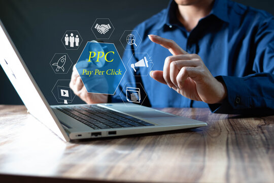 ppc pay per click advertising in search engine platform digital marketing strategy and goals businessman using laptop displaying icons on virtual screen