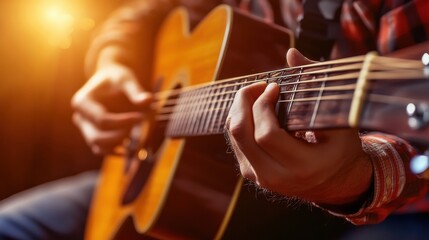 Fototapeta premium A musician focuses on strumming an acoustic guitar, demonstrating skill and passion while sitting indoors. The warm glow of evening light enhances the cozy atmosphere