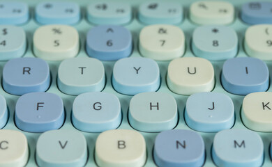 Close up of a modern computer keyboard with a cute, contemporary blue design seen from above.
