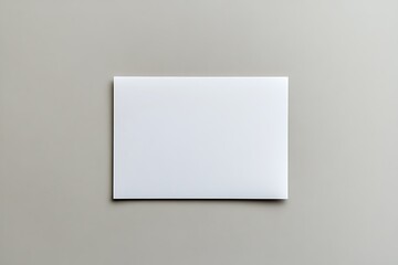 Fototapeta premium Minimalist White Rectangular Paper Sheet on Gray Background Display Layout