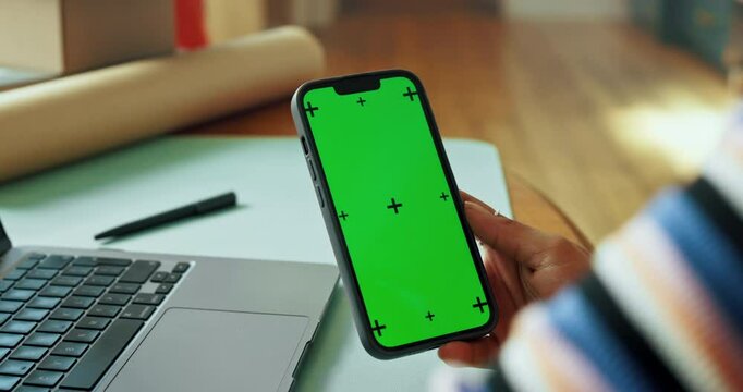 Mobile, green screen or hand at laptop for small business, connectivity or mockup space. Entrepreneur, person or tech at desk for startup management, online review or web update with tracking markers