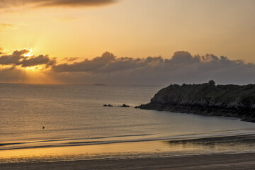Fototapeta premium View of the sandy beach at low tide and sunset of Saint-Cast-Le-Guildo in summer in Côtes d'Armor, Brittany, France