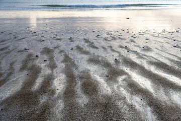 View of the sandy beach at low tide of Saint-Cast-Le-Guildo in summer in Côtes d'Armor, Brittany, France