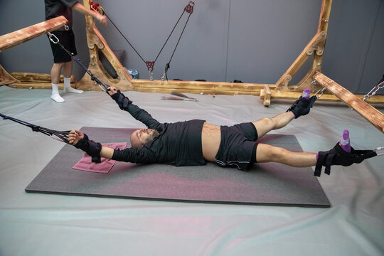 Patient undergoing spinal decompression therapy with stretching straps