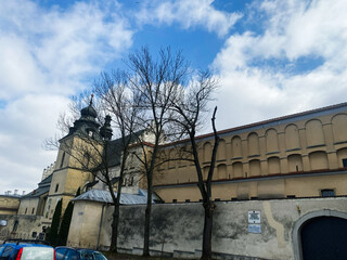 Historic building with trees in Krakow, Poland under a bright blue sky