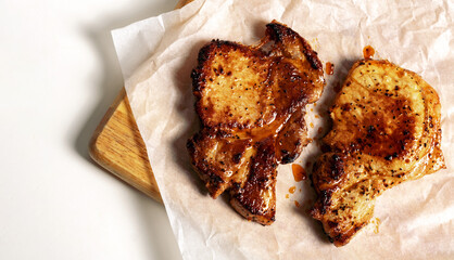 Fried pork steak on kraft paper top view