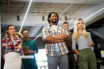 Portrait of successful creative business team looking at camera, smiling. Startup success concept.