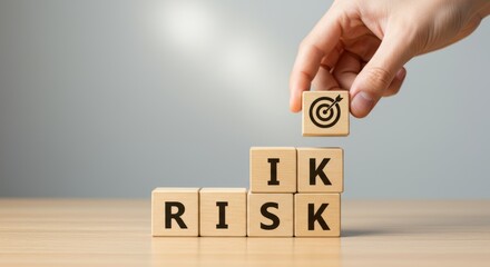 Managing Business Risks Concept: Hand Placing Target Block atop Stack Spelling 'RISK'