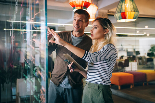 Group of young multi-ethnic startup business team collaborating on project in modern office