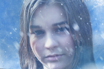 Girl during a winter cold. Frozen woman shivering from cold weather on a blue snowy background.