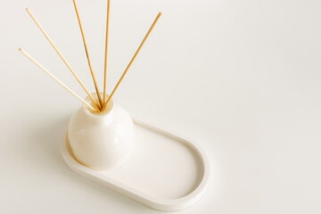 Home fragrance diffuser on white table  background isolated top view with copy space, Aesthetic scandinavian interior accessories. Minimalistic home decor