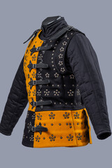 Two-Tone Medieval Brigandine Armor with Buckles. Unique torso protection featuring contrasting yellow and black panels with decorative rivets and leather strap closures.