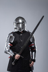Fototapeta premium Knight in Full Plate Armor Holding a Sword.