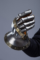 Silver Hourglass Gauntlets with Brass Details. This image shows a close-up of a pair of shiny...
