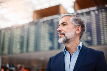 Mature businessman in an airport terminal looking serious and focused