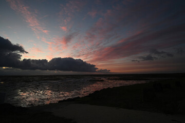 Fototapeta premium sunrise with clouds over the beach
