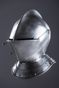 Shiny Silver Medieval Armet Helmet with Visor. This polished silver armet features a hinged visor and bevor, offering full head protection in medieval style.