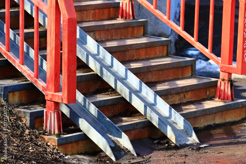 Aufkleber Close-up view of a staircase with bold red railings, suitable for interior design or architecture-related images.