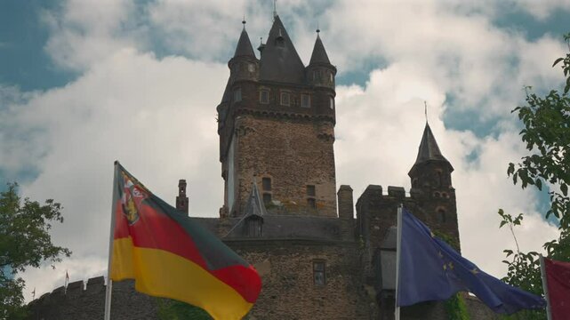 Reichsburg Cochem Castle Framed by German and EU Flags &ndash; Cochem, Germany
