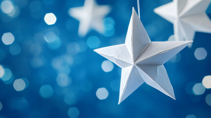 Obraz premium White paper stars hanging against blue night sky
