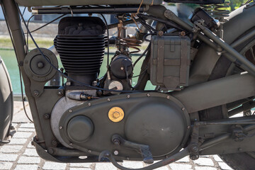 Motorcycle engine is old and has a military appearance