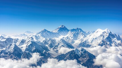 Fototapeta premium Experience the stunning aerial perspective of the Himalayas, where towering snow-covered peaks rise against a vibrant blue sky