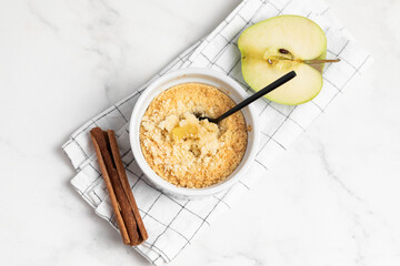 Apple crumble with streusel, light table. Morning breakfast.