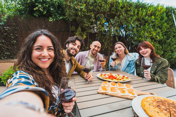 Friends Taking Selfie at Outdoor Lunch with Wine and Snacks - Smiling group of friends taking a...