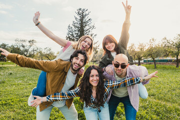 Group of Friends Having Fun and Posing in Field at Sunset - Young friends posing with energy and...