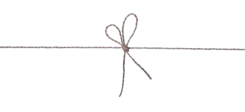 A bow tied in the center of the thread in the form of a heart is isolated on white. 