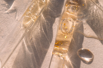 Close-up of glass pipettes with moisturizing serum with colloidal gold.