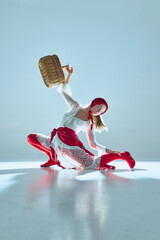Woman lifting basket above her head in sculptural pose, white-red outfit merging nostalgia with...