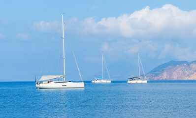 Fototapeta premium sailing yacht boats with white sails in blue sea . Luxury yachts Regata.Sailing in the wind through the waves at the Sea