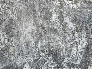 Gray wall background with cracks and spots on gray background