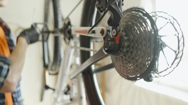 Man is performing maintenance on his mountain bike. Concept of fixing and preparing the bicycle for the new season